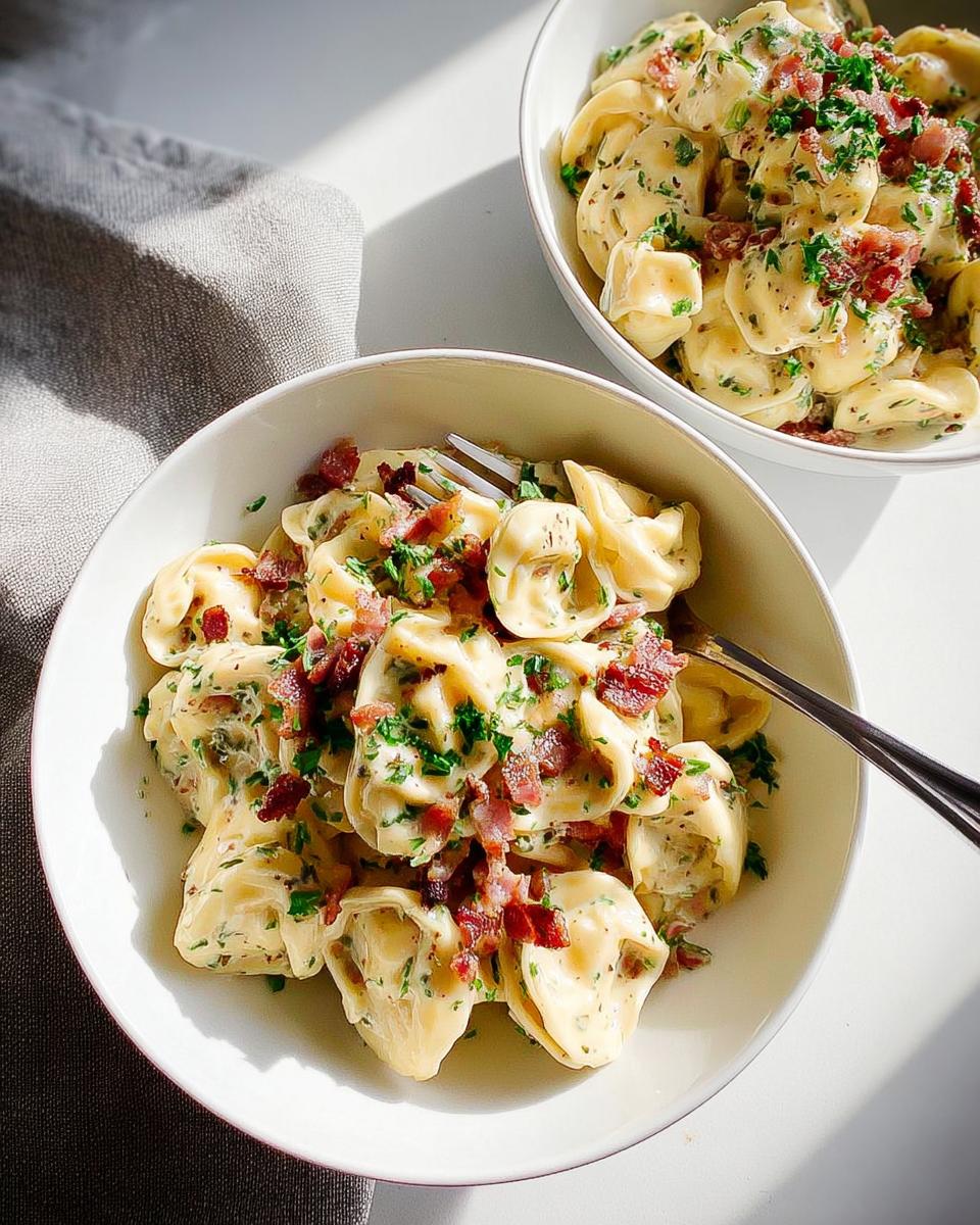 Close-up of creamy tortellini pasta with bacon bits and parsley, part of 5-Ingredient Pasta Recipes.
