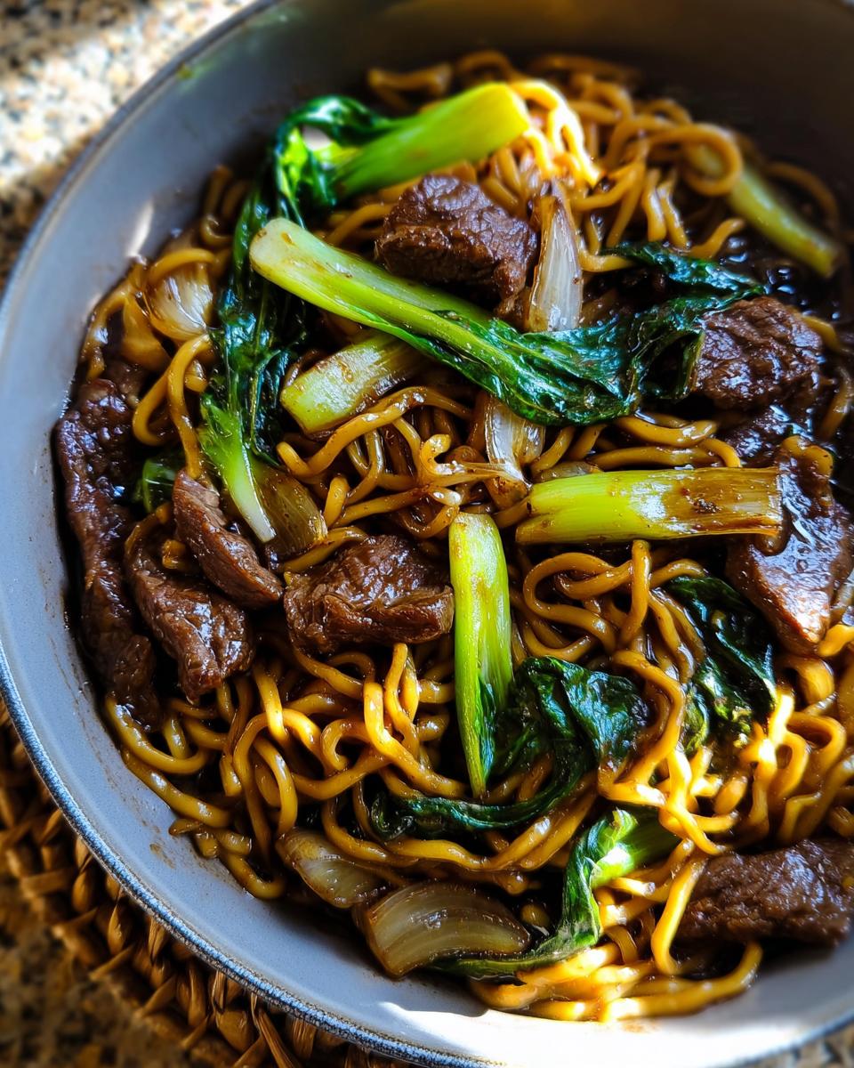 Close-up of a bowl of noodles with beef and bok choy, a delicious easy dinner recipe.