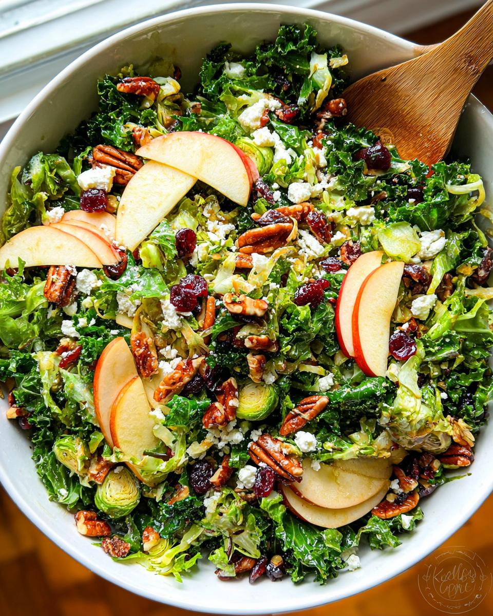 A vibrant One-Pan Thanksgiving Salad filled with kale, Brussels sprouts, apples, cranberries, pecans, and feta cheese.