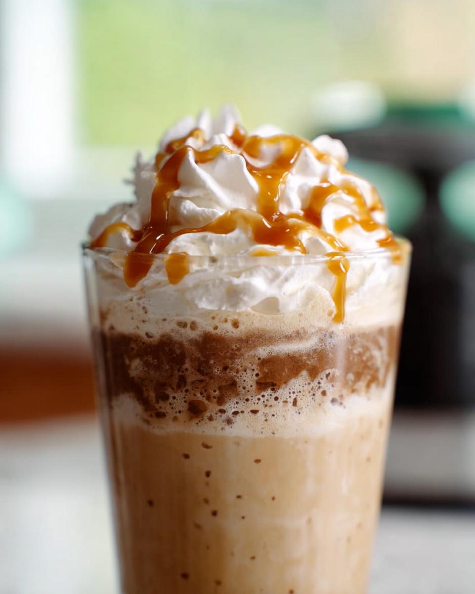 A close-up of a caramel frappuccino topped with whipped cream and caramel drizzle, perfect for Starbucks drinks for busy weeknights.