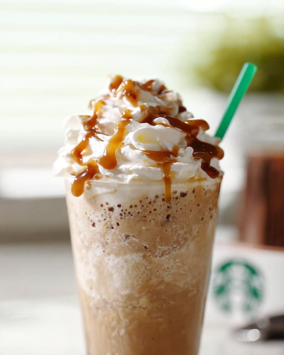 A delicious Caramel Frappuccino, one of the Starbucks drinks for busy weeknights, topped with whipped cream and caramel drizzle.