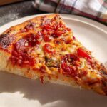 A mouthwatering slice of pepperoni pizza, perfect for Pizza Night Recipes Meal Prep, with melted cheese and a crispy crust.