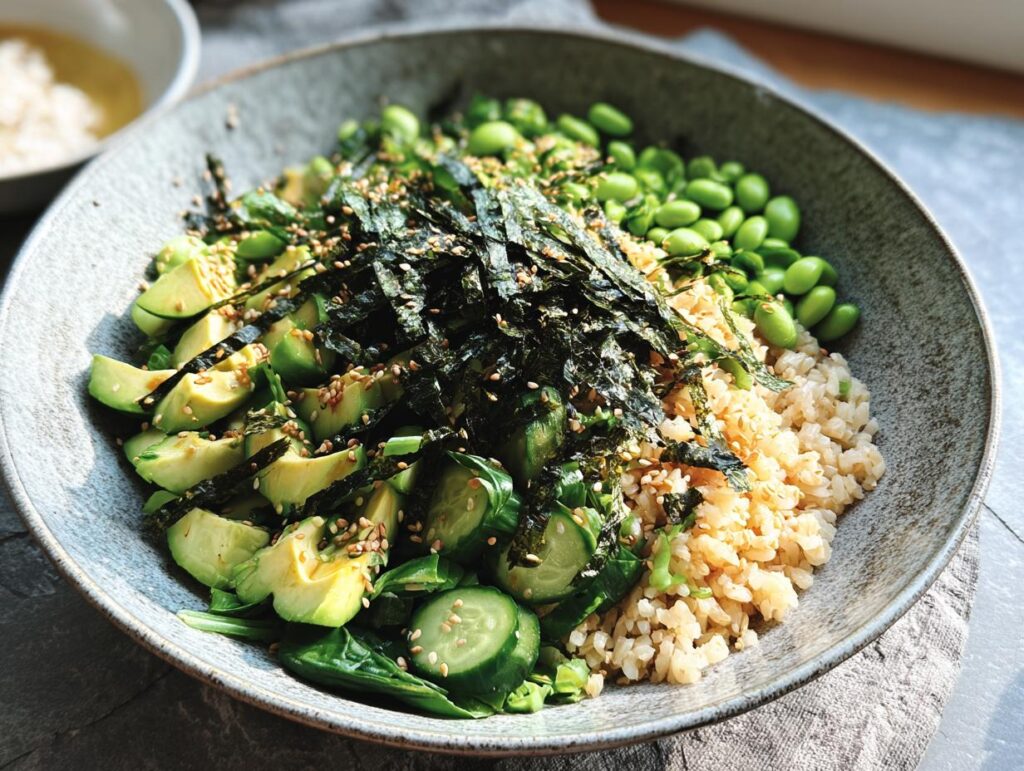 A vibrant rice bowl featuring brown rice, sliced avocado, edamame, cucumber, and nori strips, part of The Ultimate Rice Bowls Recipes Guide for Beginners.