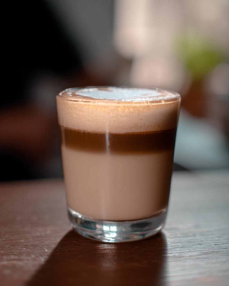 A layered Starbucks drink with foamy top in a clear glass, perfect for busy weeknights.