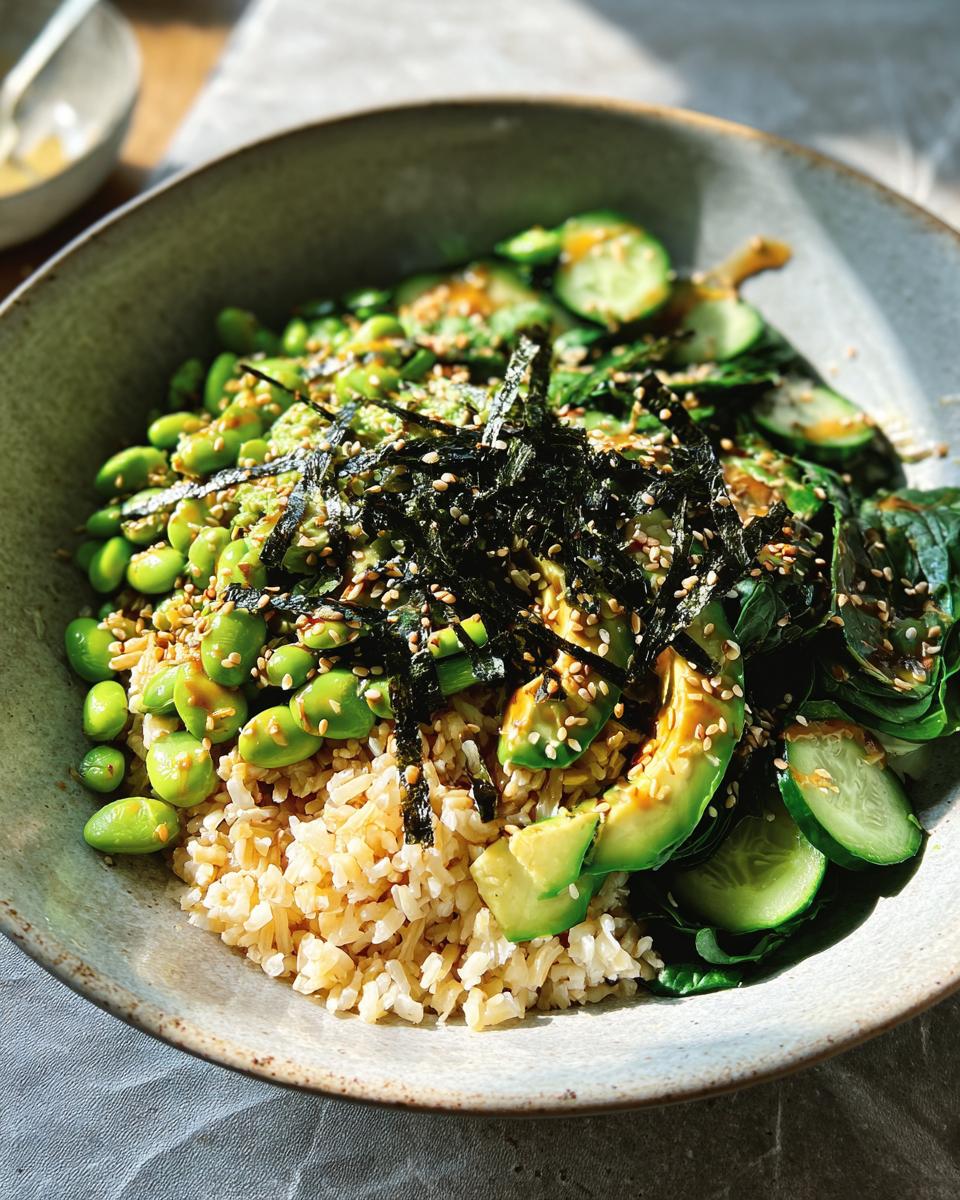 A vibrant and healthy rice bowl featuring brown rice, edamame, avocado, cucumber, and seaweed, part of The Ultimate Rice Bowls Recipes Guide for Beginners.