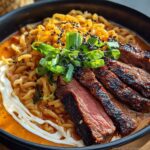 A bowl of Spicy Korean Ramen with Grilled Beef & Creamy Sauce, featuring noodles, tender beef slices, and a swirl of creamy sauce.