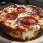 A close-up of a golden-brown Cottage Cheese Pizza Bowl topped with melted cheese and pepperoni slices.