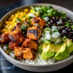 A delicious Easy Street Corn Chicken Bowl filled with rice, grilled chicken, corn, black beans, avocado, and cilantro.