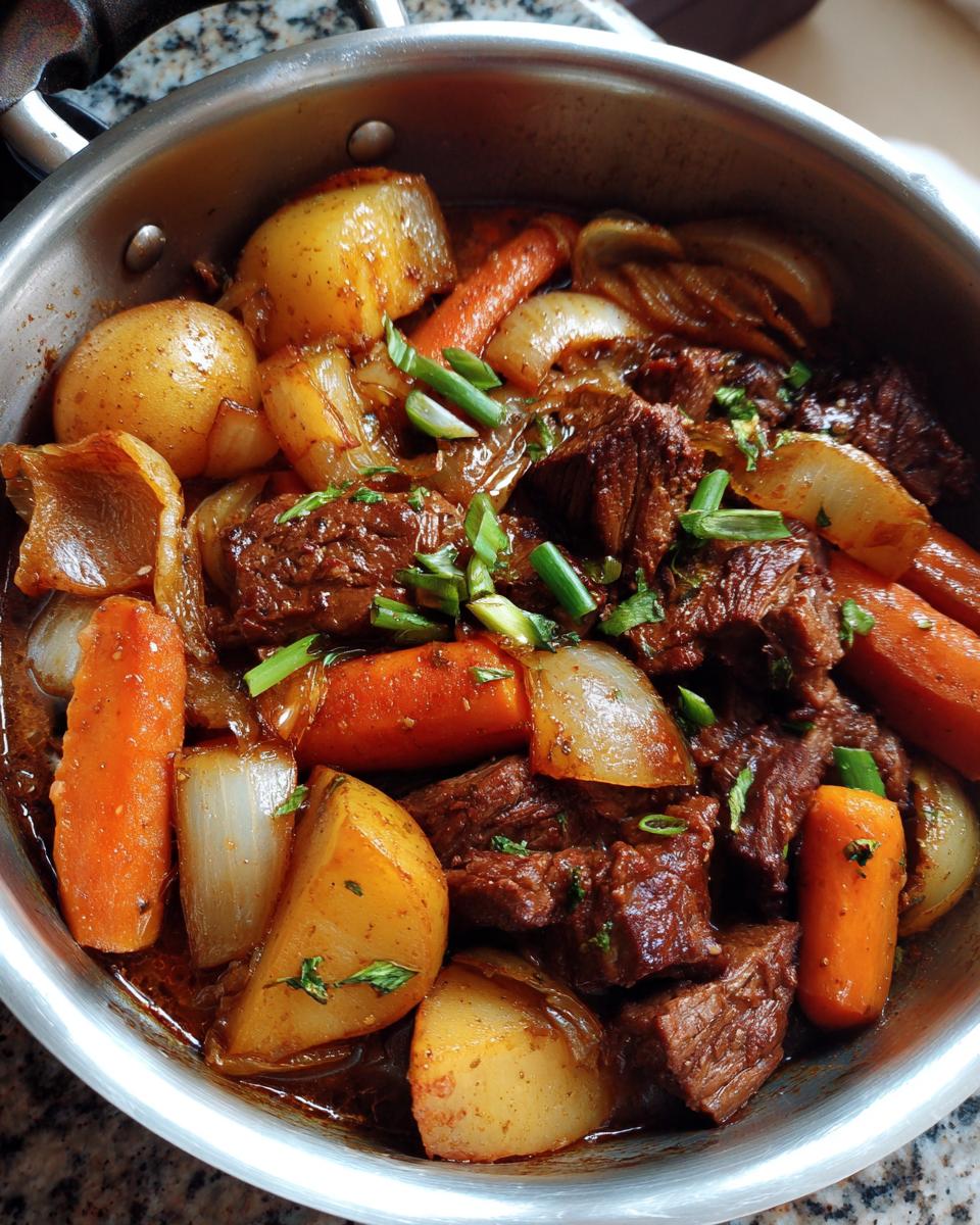 Close-up of a pot of Korean Style Pot Roast with tender beef chunks, potatoes, carrots, and onions in a rich sauce.